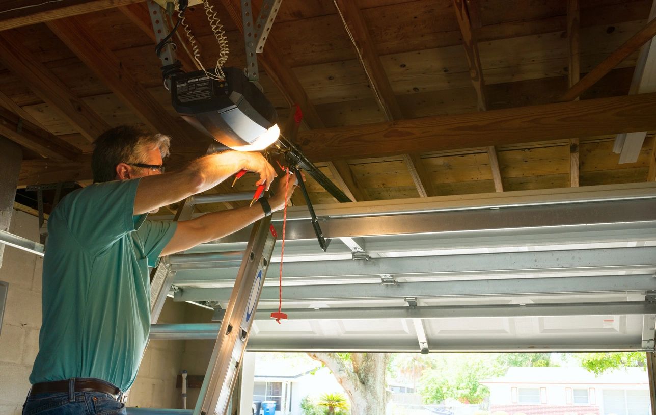 Man installing fixtures in garage unit inside a house